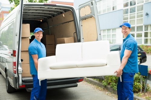 Man with van loading furniture in Earls Court street